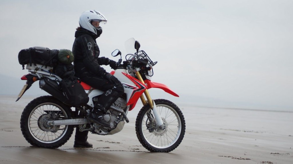 Women Who Ride: Steph Jeavons on her Honda CRF250L on a beach in Wales